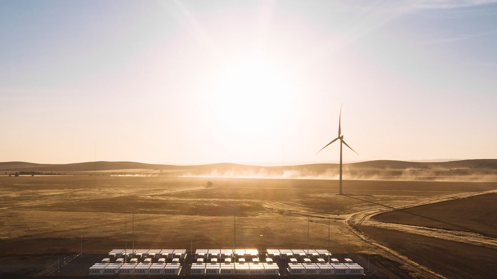 A grid scale battery storage installation under a blue sky.