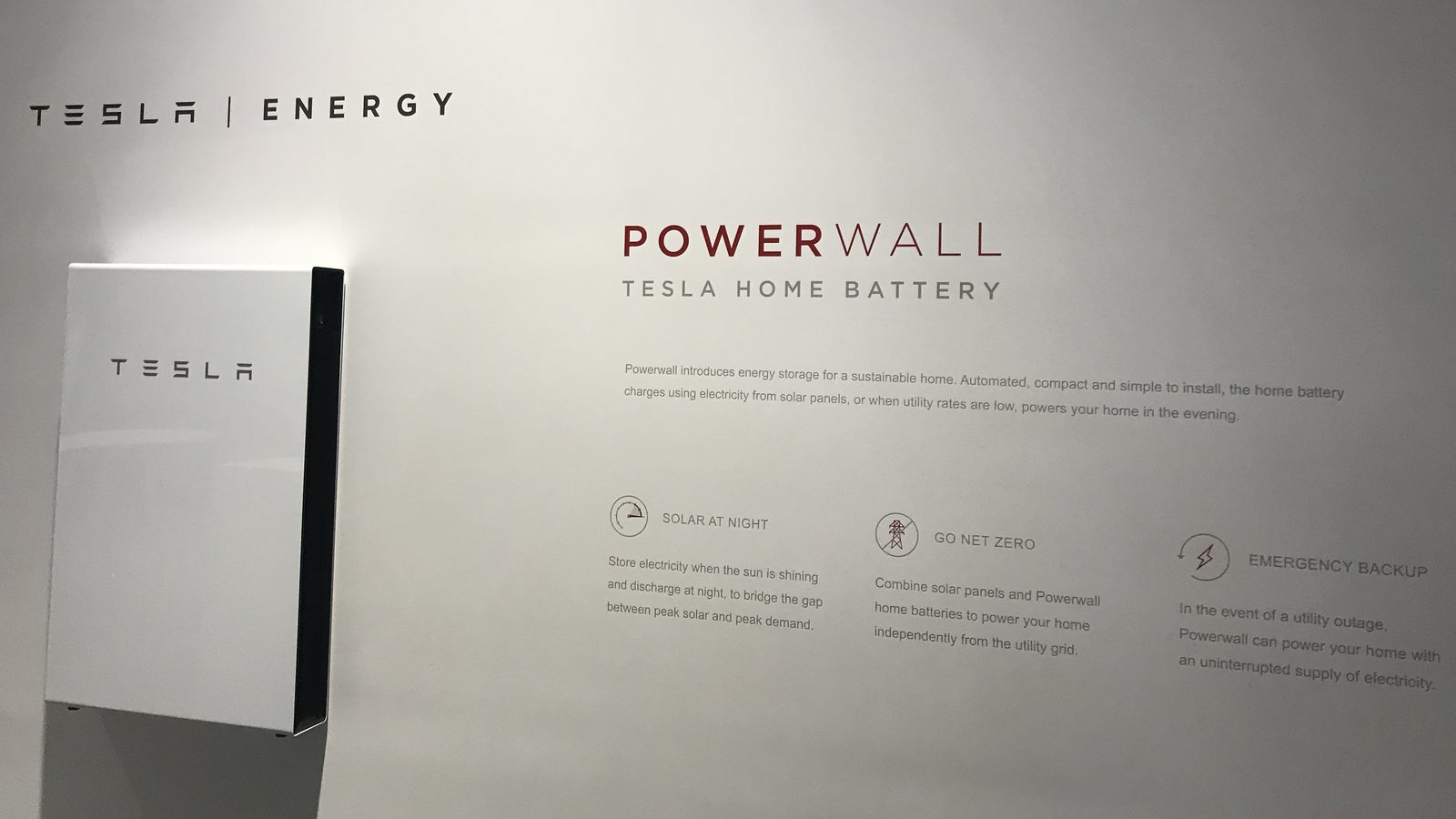 Home battery units mounted on a brick wall, marking the Cheaper Home Batteries Program 500,000 installation milestone.