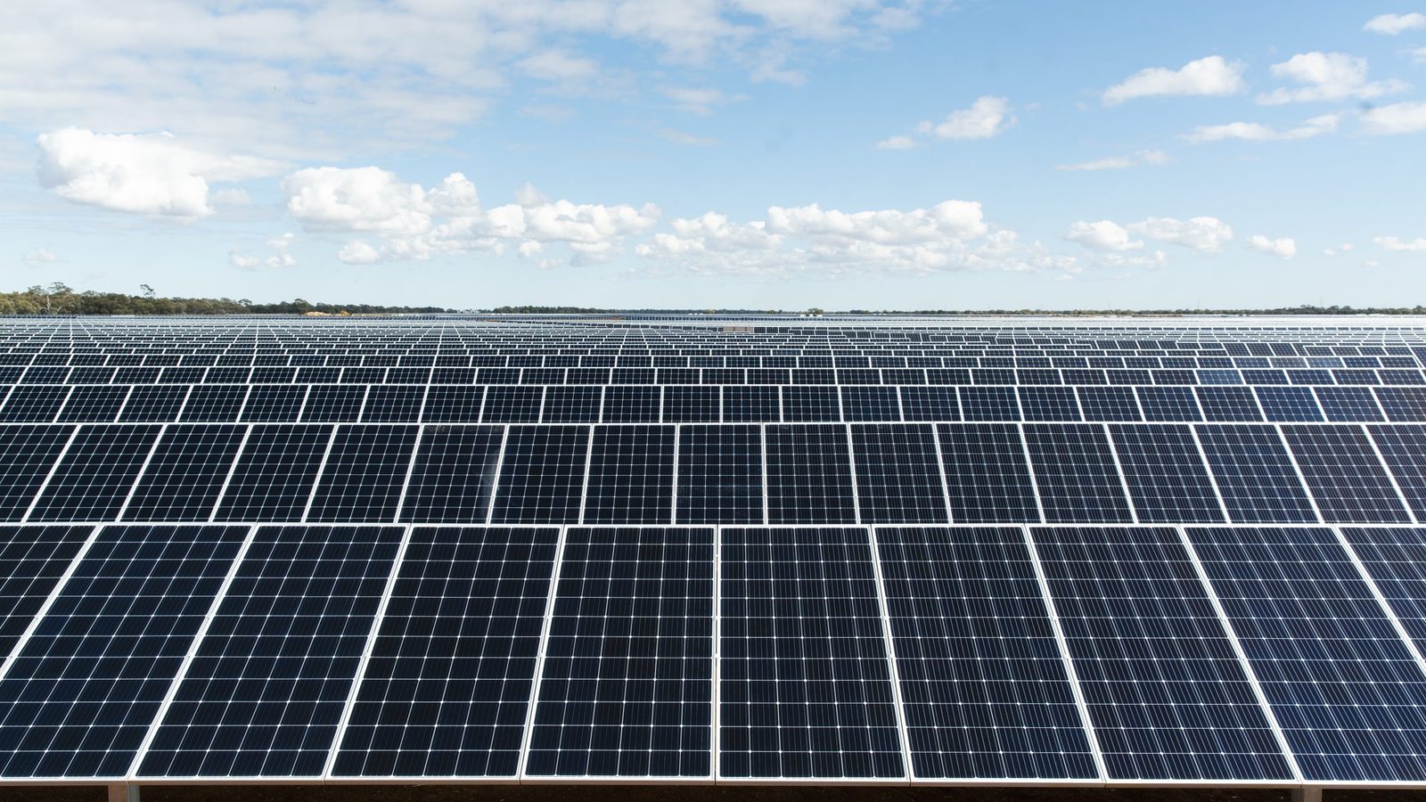 Large scale solar farm generating electricity under a clear winter sky