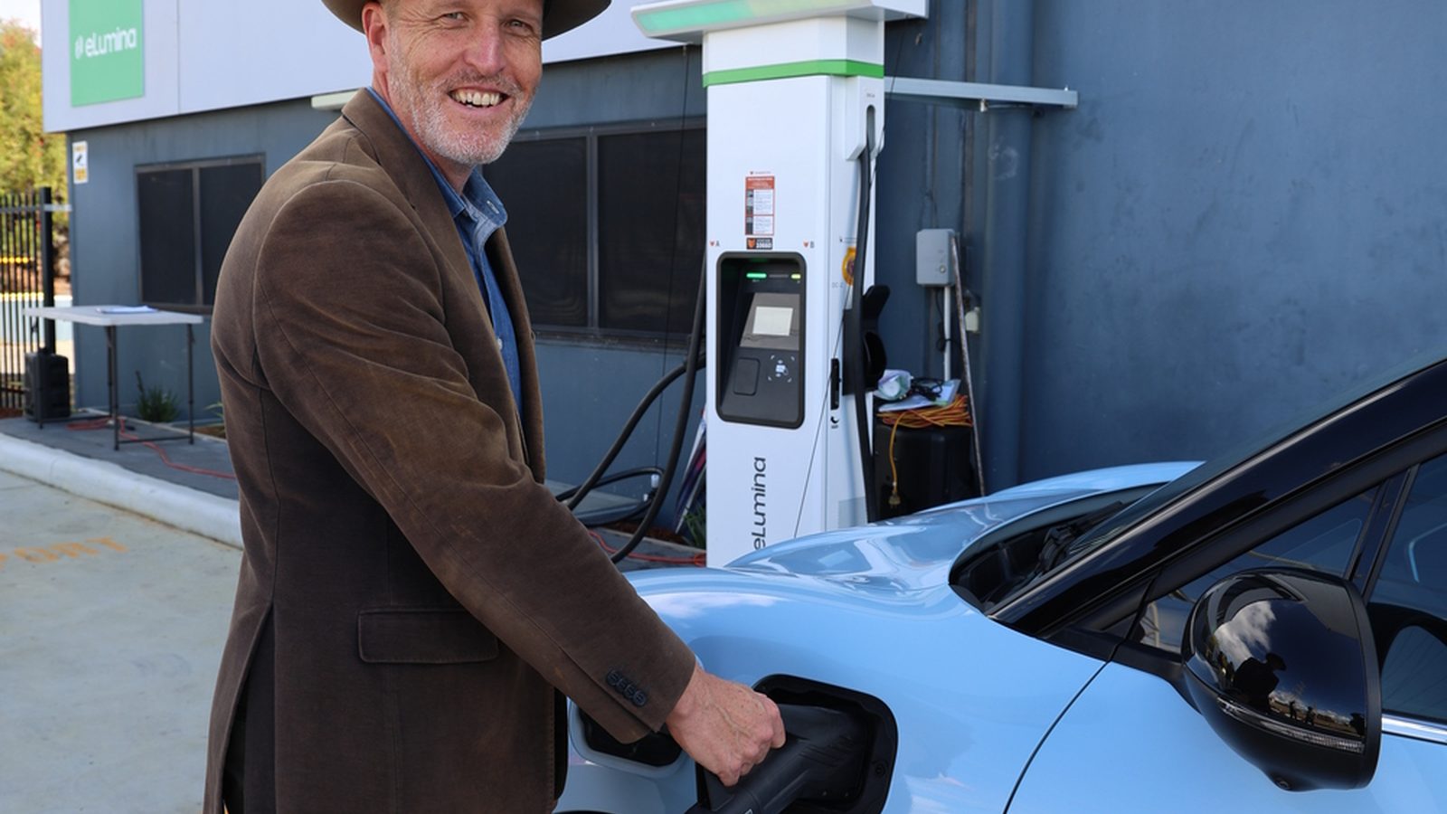 Australian home with rooftop solar, a wall mounted EV charger, an electric car and a home battery
