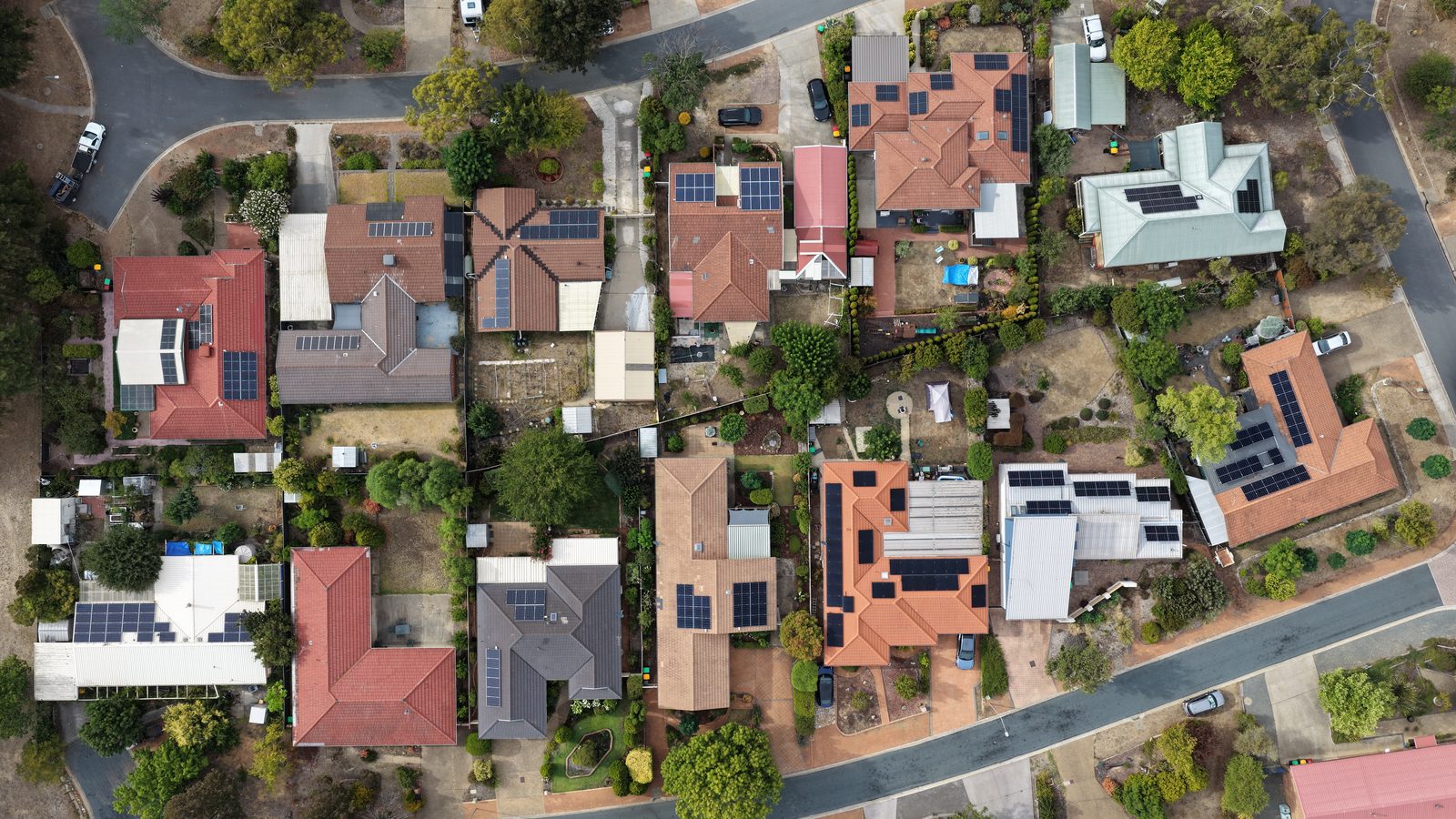 Rooftop solar panels on an Australian home under a clear sky.