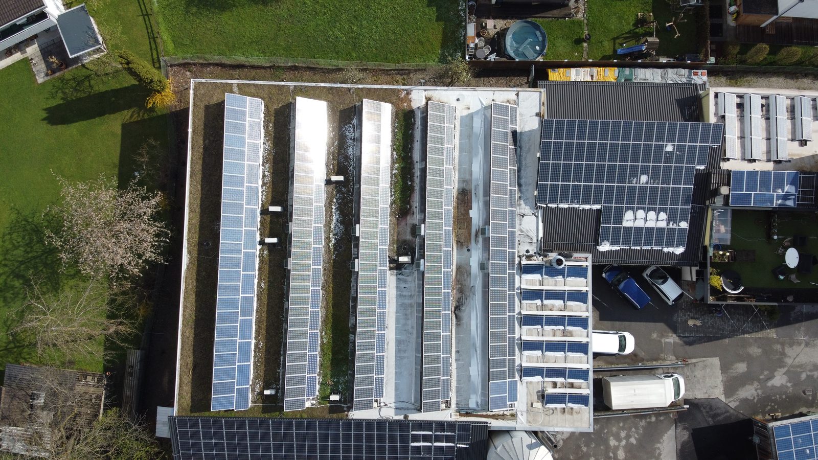 Australian home with rooftop solar, a wall mounted EV charger, an electric car and a home battery